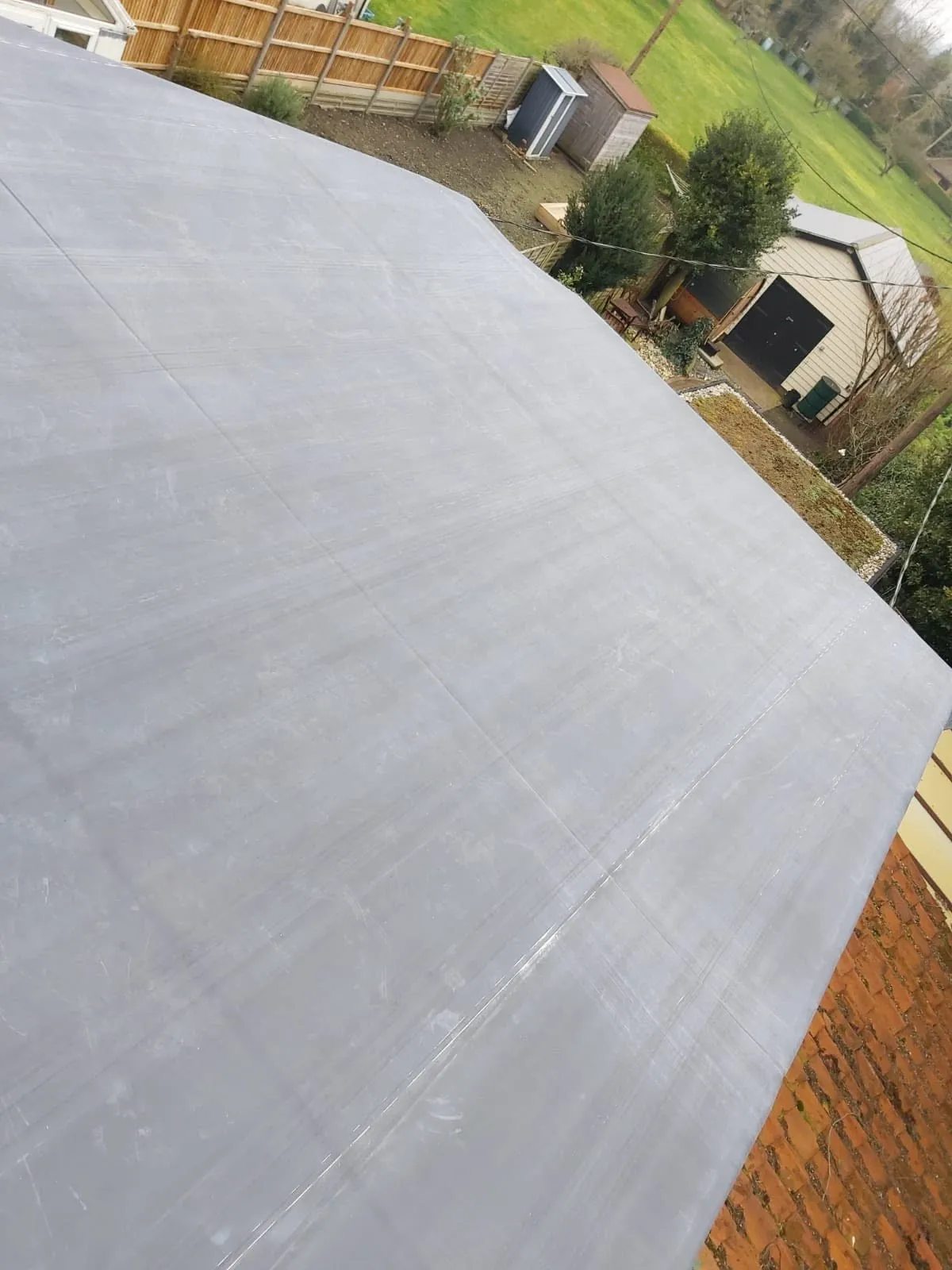 New flat roof finished in dark roofing felt