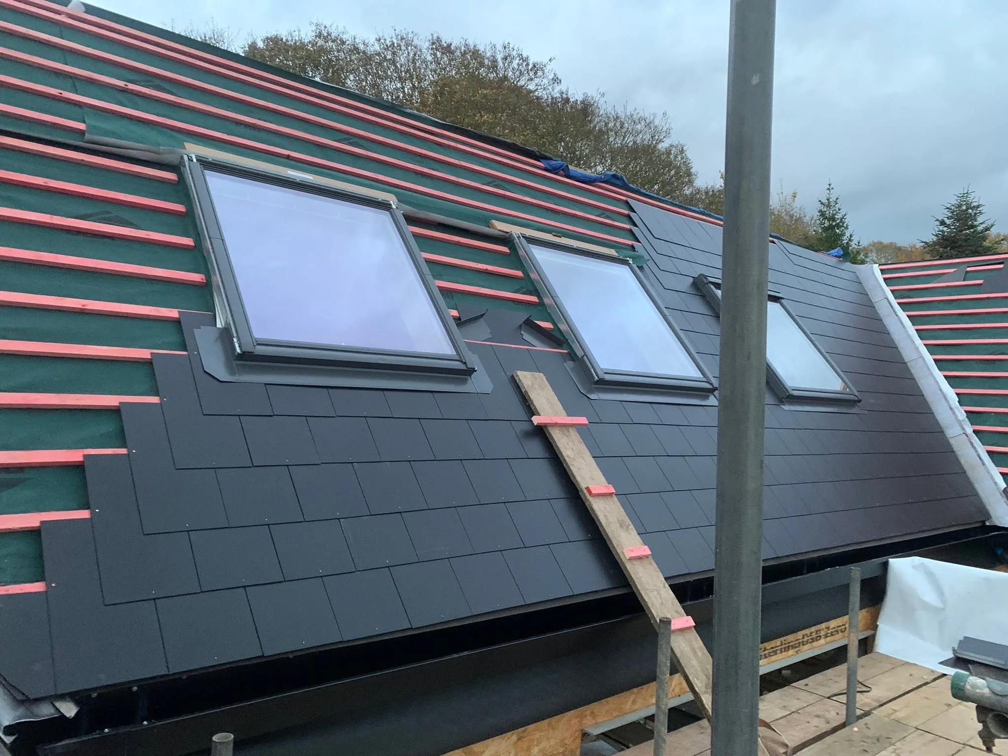 Slate re-roof in progress with new roof windows fitted