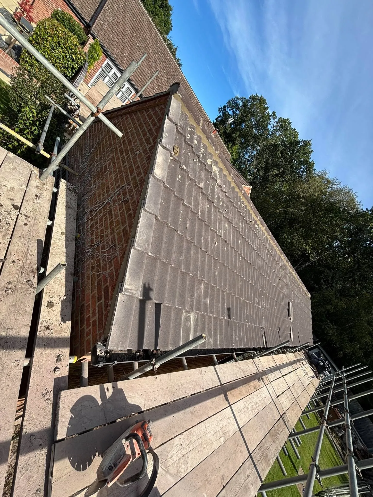 Re-roofed tiled slope with new ridge capping