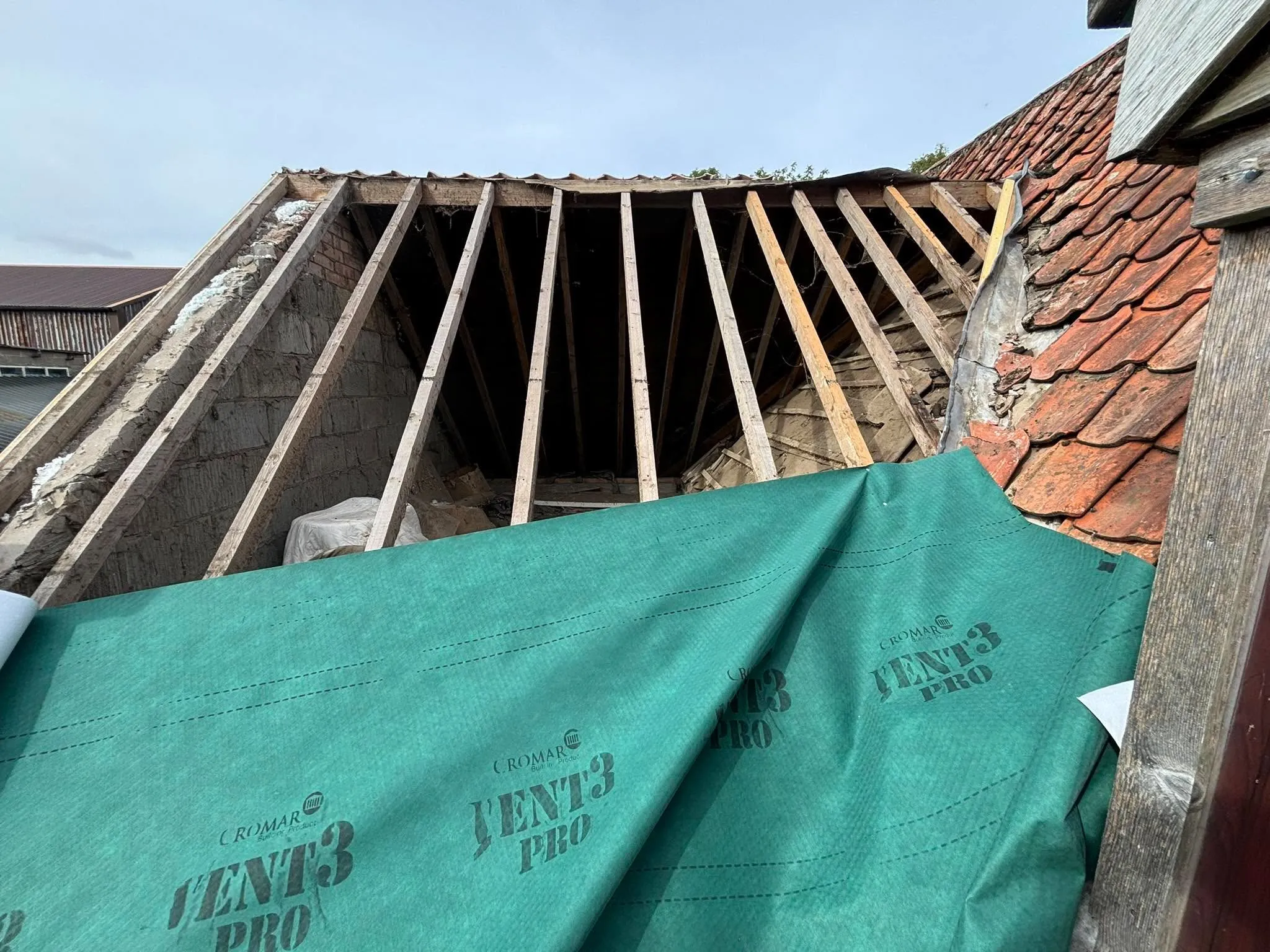 Roof stripped back to bare rafters before new membrane